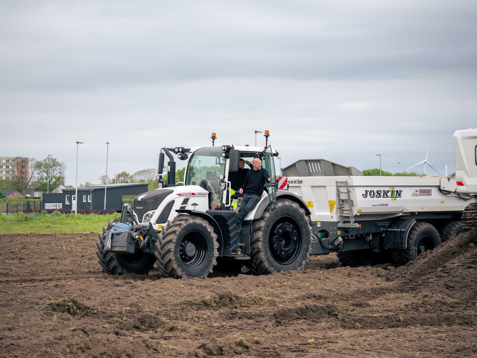 Fendt 724 Vario zieht einen Kipperanhänger auf dem Feld